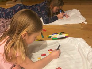 sisters decorating scrub bags for NHS